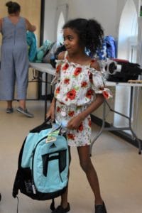 Ellis Memorial Student excited about her new backpack donated by McSweeney & Ricci Insurance