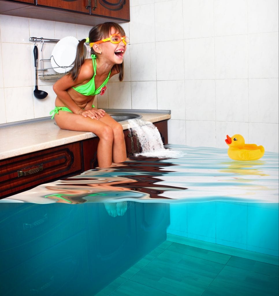 Little Girl Laughing as she floods the kitchen of her home insurance claim