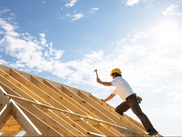 Roofer working on roof insurance for general contractors