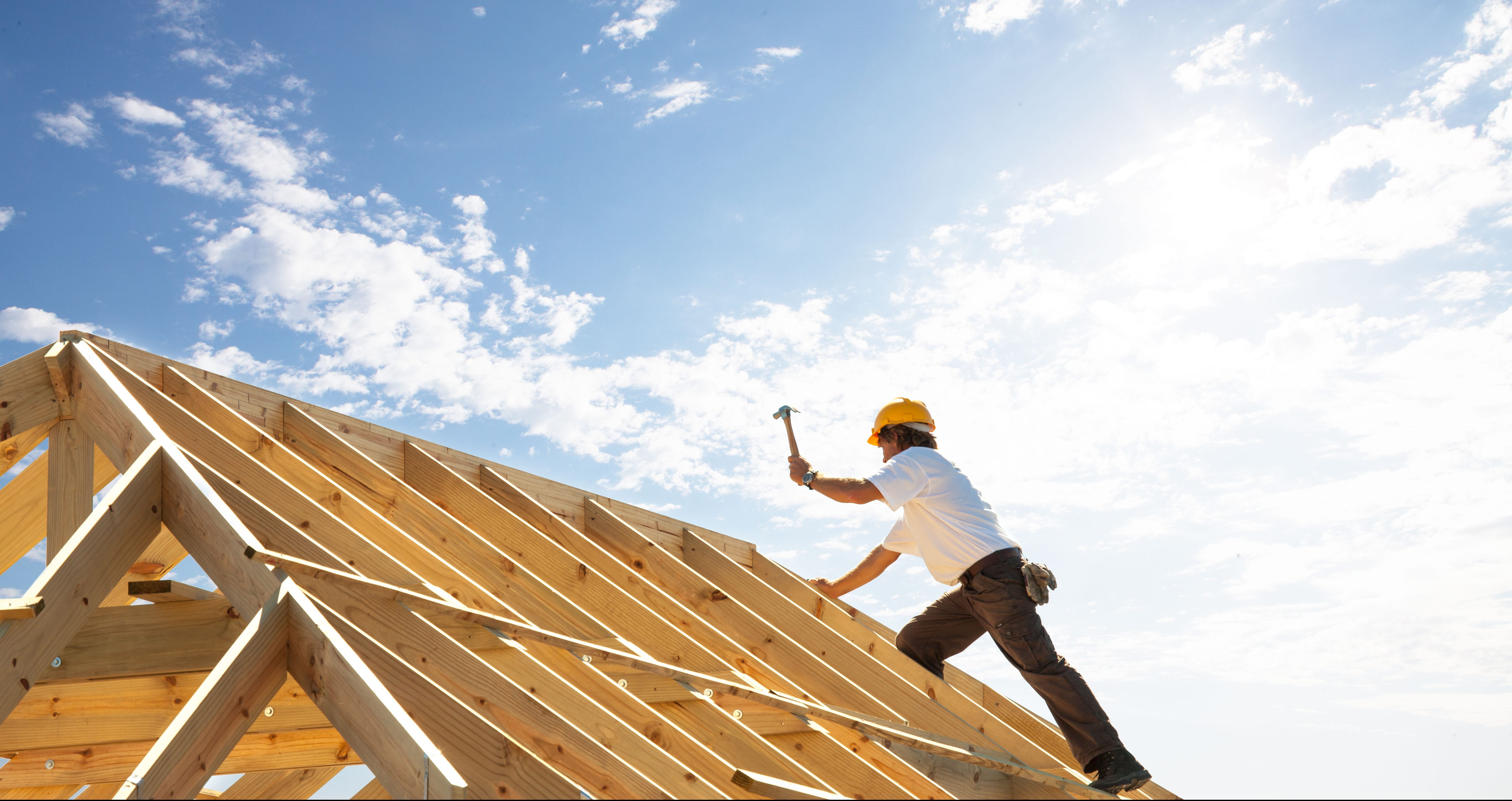 Roofer working on roof insurance for general contractors