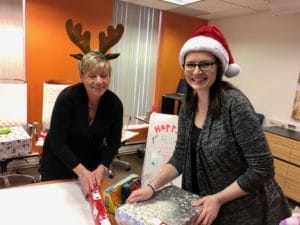 Leslie Hickey and Carol Sesin wrap their gifts