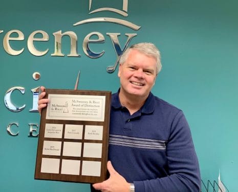 Director of Information Technology, Kevin MacDonald holds Employee of the Year Plaque