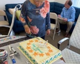 Sandi Cohen cuts her retirement cake